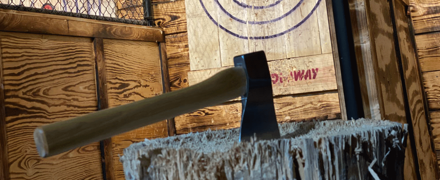 throwing axe stuck in wooden stump